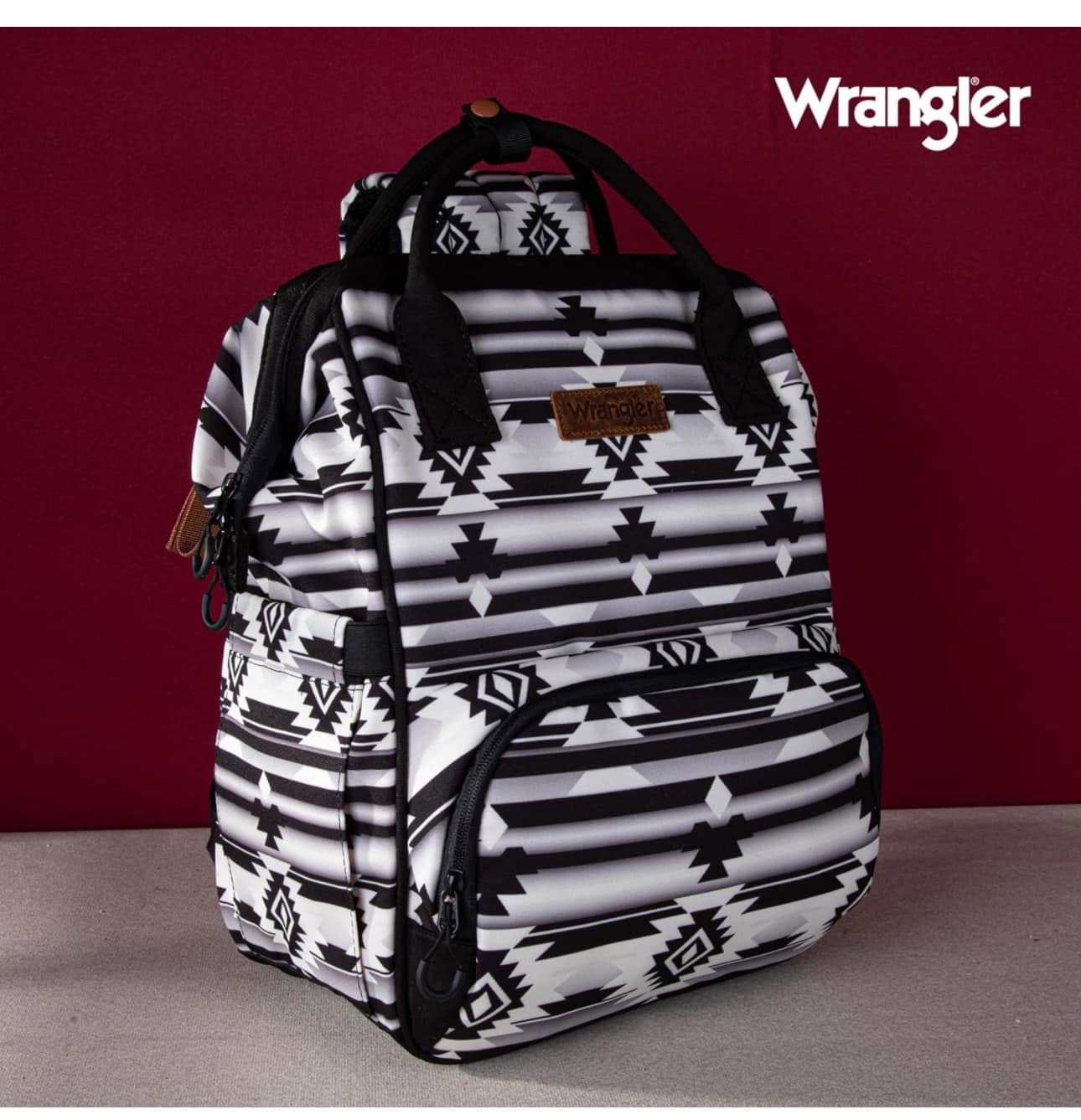 Black and ivory western print Wrangler backpack displayed against a deep red background
